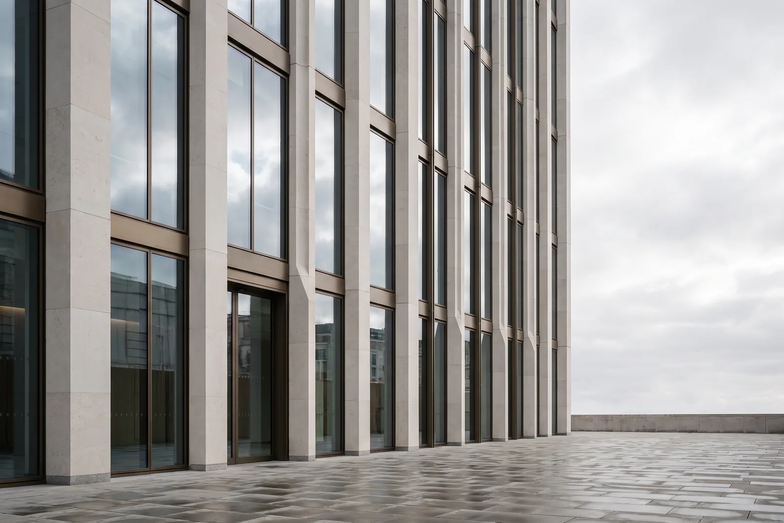 One Ashdown Place — completed office tower with Portland stone piers and bronze framing